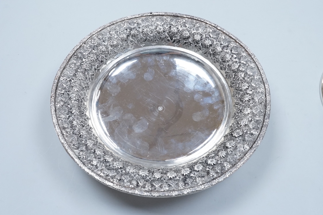 A 20th century Middle Eastern white metal circular dish and cover, embossed with flower heads, stamped '84', base diameter 24.2cm, 28.2oz.
